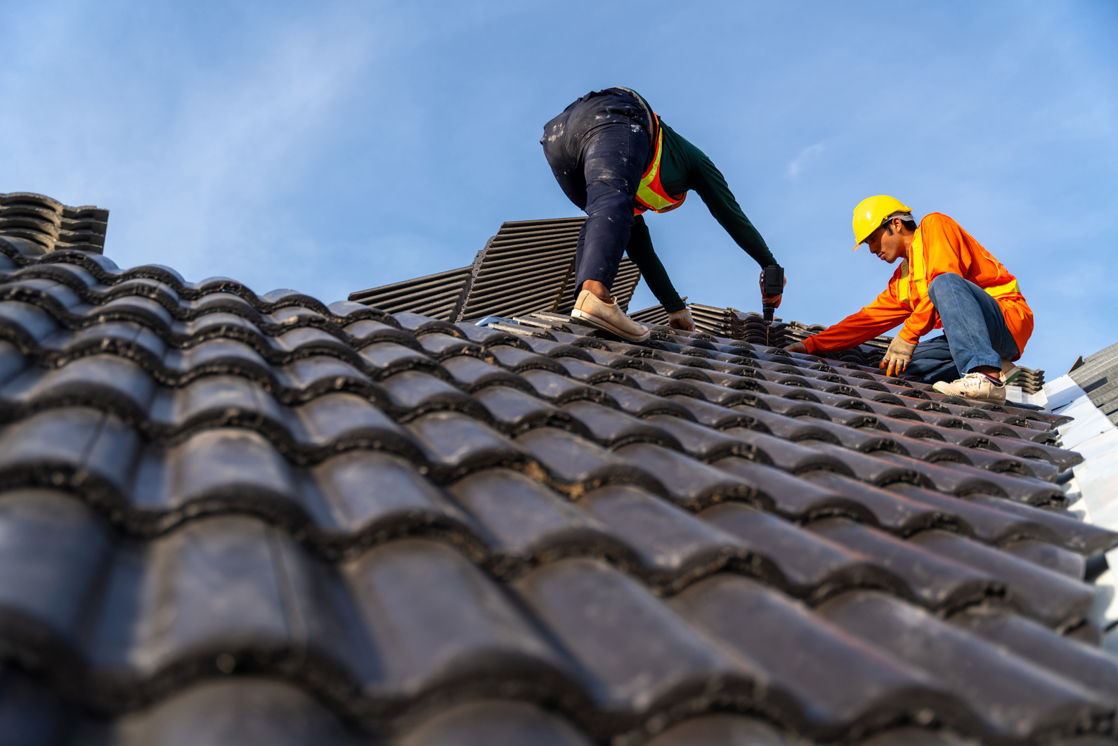 2 roofers working on the working at height to install the Co